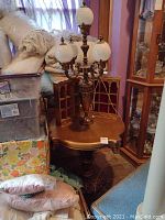 Overall view of lamp table with two display shelves