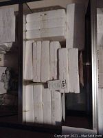 White styrofoam boxes stacked in multiple rows containing collector plates, some labeled with marker writing.