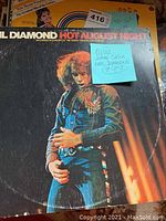 Photo showing Neil Diamond Hot August Night LP with Elvis, Johnny Cash and Neil Diamond note