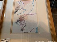 Framed Indian art print depicting Native American figure with flowing ribbons in soft colors.