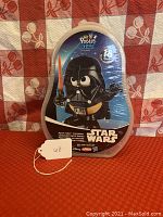 Photo of original sealed Mr. Potato Head Darth Vader figure in box with 18 pieces indicated, front view with blue background and Star Wars branding.