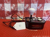 Front angle showing joystick, two Buttons, and attached cable with AV connectors