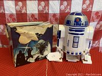 Photo showing R2D2 cassette player alongside a Star Wars book with damaged cover