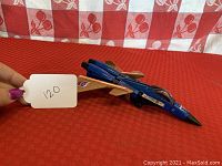 Front angle of the Takara Transformers jet showing blue and gold color with Decepticon insignia on wing and tail.