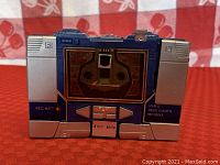 Closer front view highlighting buttons and text labels on the toy cassette player.