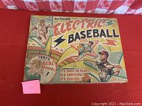 Closed box of the game showing colorful illustrated lid with players and text: Electric Baseball by Jim Prentice with slogan and graphics