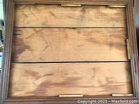 Backside of the wooden antique farmhouse mirror frame showing wood planks and part of the frame construction