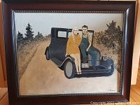 Framed original painting by Steve Albertson showing a man and woman sitting on the front bumper of a black vintage car in a rural setting.