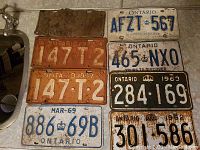 Collection of 9 vintage Ontario metal license plates from years 1937 to 1963, showing signs of rust and wear.