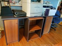 Front view of modular cabinetry tops with two woodgrain cabinets and one open shelf unit beneath, and desk chair beside