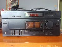Front of JVC stereo receiver with equalizer sliders, volume knob, and digital display.
