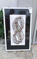 Front view of framed MC Escher print with ants on a Möbius strip, white frame and acrylic cover