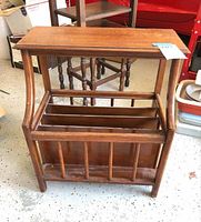 Image showing the wooden vintage magazine rack telephone stand from a front angle, highlighting the slatted magazine holder and sturdy legs.