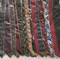 Photo of 14 assorted silk neck ties in various patterns and colors laid out in a row.