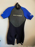 Front view of the men's Body Glove wetsuit, short sleeves, short legs, black and blue color, showing logo on chest