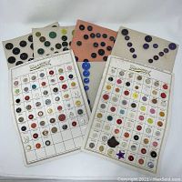 Two Streamline button cards with many varying buttons pinned on a white surface.
