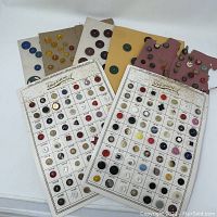 Photo showing five vintage button cards with various buttons of multiple colors and styles arranged in rows and columns.