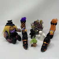 Overview of all Halloween-themed items including trolls, witch shoes, ghost figurines, and haunted house shaker set.