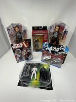 Photo showing full lot with two Jyn Erso action figures, two additional Star Wars figures in packaging, a three-figure pack and small vehicle with Stormtrooper.