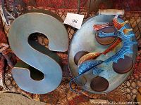 Large metal letter S and metal round candle holder with seahorses.