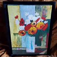 Full view of the framed abstract floral painting showing vibrant colors and flower details.