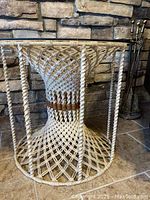 Single macrame table showing detailed woven rope base design and tinted glass top.