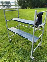 Full view of the mini scaffolding showing its overall construction with platforms and caster wheels.