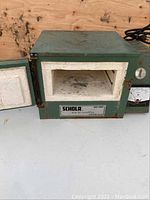 Front view with door open showing firebrick-lined interior