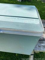 Top view of Koolatron electric cooler, light blue with embossed branding on lid.