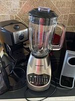 Photo showing Black & Decker blender, espresso maker and coffee pod holder on counter