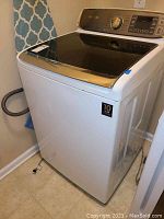 Full front and top view of the washer showing overall condition and design