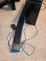 Curved soundbar and subwoofer placed on carpet