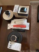 Two Samsung smart watches with six watch bands and their boxes on a table, showing the full lot contents.