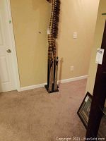 Photo showing two metallic human figurine statues on a black base next to a tall giraffe figurine with striped pattern.