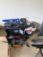 Overview of Craftsman cordless drill, charger, black case and Skil circular saw box
