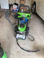 Full view of pressure washer with frame, wheels, hose and wand