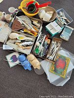 Overview of all kitchen items on display showing utensils, mugs, colanders, and other tools