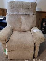 Front view of a beige fabric recliner chair with padded arms and cushioned backrest.