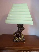 Full view of vintage ceramic horse lamp showing glazed brown and cream-covered rearing horse base with stepped white metal lampshade.