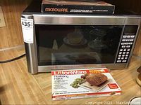 Photo of Hamilton Beach microwave with bacon rack on top and boxed LittonWare roasting rack in front