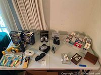 Overview of all items on table showing binoculars, cards, wooden boxes, whistles, and poker chips.