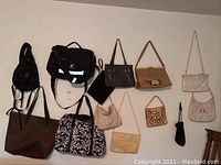 Overview photo of 13 assorted bags including two black Patagonia Georgia Film bags, multiple handbags and totes in various colors and styles.