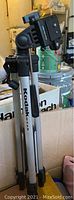 Photo of Kodak tripod standing upright showing adjustable legs and mounting plate.