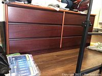 Front view of the six-drawer dresser showing the drawer configuration and wood finish.