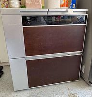 Front view of Dimchae kimchi refrigerator showing two brown-panel drawers under a tinted control panel.