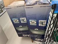 Two Oster electric griddles boxes showing product images and branding.