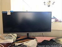 Front view of 34" Samsung ultra-wide monitor on stand