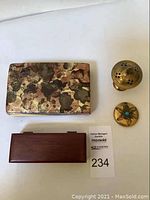 All items laid out showing two boxes, a brass ornamental container with holes, and a small gold-tone round container with a turquoise center.
