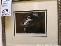 Framed black and white print featuring a character with a large feathered hat and cane, with label showing dimensions 12x13 inches.