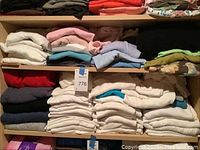 Folded assorted women's printed t-shirts in various colors and patterns